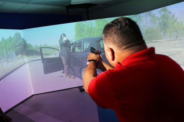 A police training officer takes part in a demonstration of the Meggitt Training System at the City of Miami Police Department's Training Center in 2018.